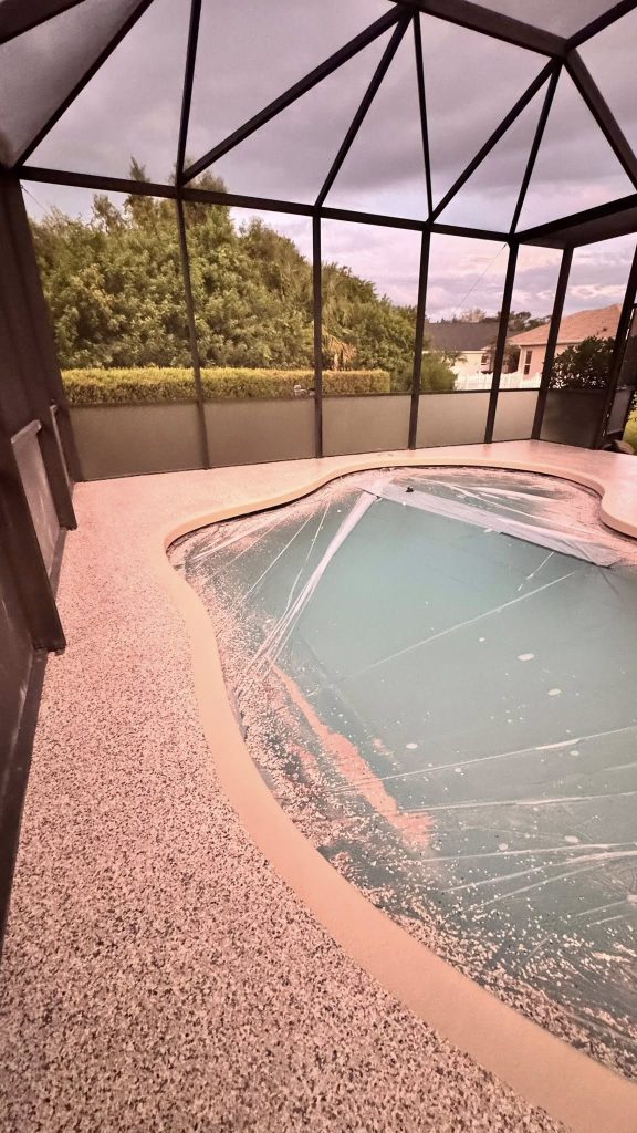 Flake epoxy pool deck coating around a screened-in pool