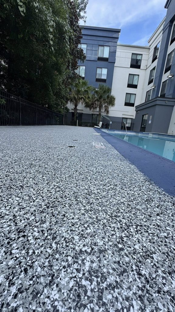 Gray and white flake epoxy coating on a pool deck