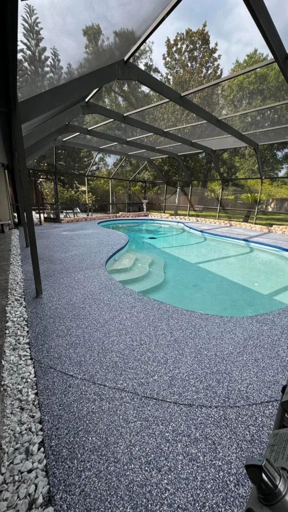 Gray flake epoxy pool deck and pool steps inside a screened enclosure