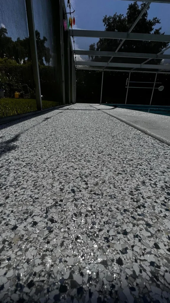 Older concrete slab resurfaced with a gray flake epoxy coating