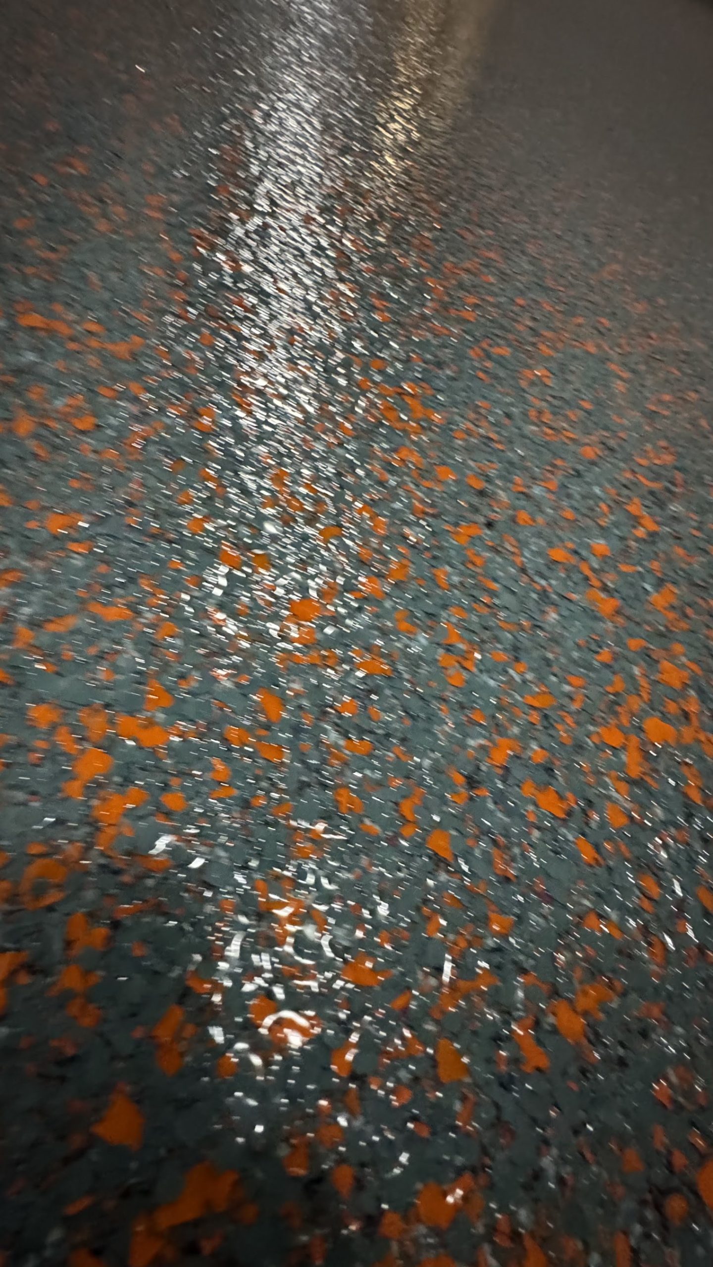 Freshly coated commercial epoxy flake floor with copper flake accents